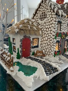 a gingerbread house is decorated with white icing