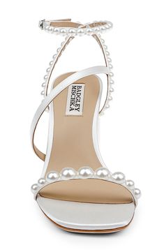 Pearly beads enrich the slender straps on an elegant satin sandal elevated by a half-moon block heel. 3 1/2" heel Adjustable ankle strap with buckle closure Cushioned footbed Textile upper/leather lining and sole Imported Wedding Block Heel Sandals, Mishka Badgley Shoes Wedding, Prom Heels Pearl, Open Toe Bridal Shoes, Fun Bridal Shoes, Wedding Shoes With Pearls, Jimmy Choo Pearl Heels, Block Heel Wedding Shoes Brides, Pearl Sandals Wedding