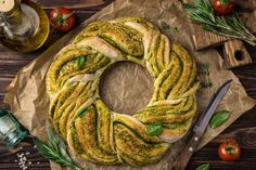 a freshly made pesto bread on a piece of wax paper next to a knife