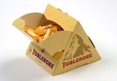 an open box of toblerone sitting on a white surface