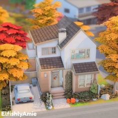 a model of a house surrounded by autumn trees