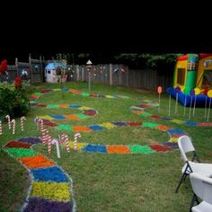 a birthday party is set up in the backyard with candy canes on the lawn