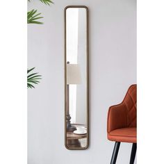 a mirror hanging on the wall next to a chair