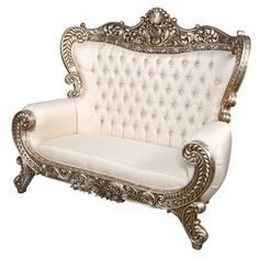 an ornate white couch with gold trimmings