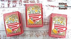 three red and white boxes with yellow flowers on them, one has a teacup in it