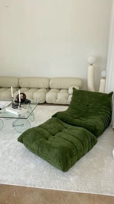 a living room filled with furniture and a large white rug on top of the floor