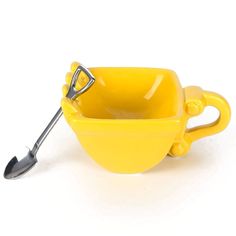 a yellow bowl with a spoon in it