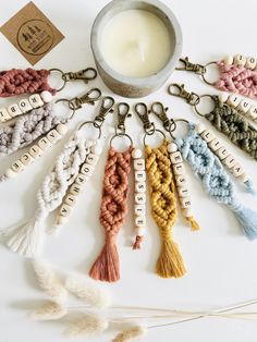 an assortment of tassels are arranged in a circle with a candle next to them