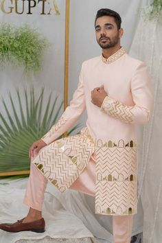 Soft pink sherwani with gold acrylic elephant, khidki motifs and pipe embellishment. Paired with kurta and pant pyjama.
Components:3
Pattern:Embroidery
Type of Work:Elephant, khidki, pipe
Neckline:Mandarin collar
Sleeve Type:Full sleeves
Fabric:Chanderi Silk, Cotton
Color:Pink
Other Details:
Front button placket
Note: Dupatta worn by the model is not for sale
Occasion:Destination Wedding - Aza Fashions Traditional Gold Sherwani With Gota Work, Festive Gold Sherwani With Gota Work, Festive Semi-stitched Sherwani With Gota Work, Pink Traditional Wear With Naqshi For Festivals, Traditional Pink Bandhgala For Designer Wear, Pink Traditional Bandhgala For Designer Wear, Designer Gold Sherwani With Gota Work, Semi-stitched Sherwani With Gota Work, Pink Bandhgala With Dabka Work For Eid