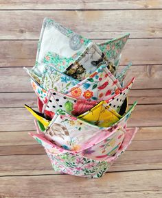 a stack of folded fabric sitting on top of a wooden table