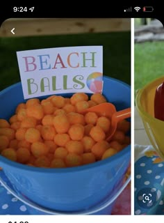 a blue bucket filled with orange balls and a sign that says beach balls on it