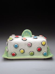 a white cake with multicolored polka dots on it