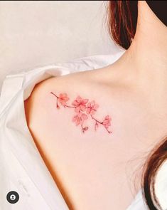 a woman's chest with pink flowers on it