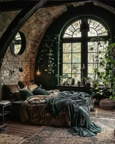 a bed sitting under an arched window in a bedroom