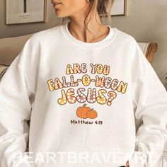 Fall Christian Sweater, Are You Falloween Jesus Matthew 4:19 Hoodie, Are You Fall-O-Ween Jesus Shirt, Autumn Christian Bible Verse Shirt ♥️ PRODUCT DETAILS: ★ GILDAN® 18000 Unisex Heavy Blend™ Crewneck Sweatshirt This well-loved sweatshirt is the perfect addition to any collection! The air-jet spun yarn and quarter-turned fabric helps eliminate creases and pilling, while the mix of cotton and polyester creates a soft and comfortable feel. * 50% Cotton 50% Polyester * Fabric weight: 8.0 oz/yd² (271 g/m²) * Pre-shrunk * 1x1 athletic rib-knit collar with spandex * Air-jet spun yarn with a soft feel and reduced pilling * Double-needle stitched collar, shoulders, armholes, cuffs, and hem * Regular fit ★ GILDAN® 18500 Unisex Heavy Blend™ Hoodie With a large front pouch pocket and drawstrings in Fall Christian Asthetic, Christain Girl Autumn, Fall Christian T Shirts, Christian Fall Shirts, Christian Sweater, Fall Christian, Christian Sweaters, Jesus Clothes, Matthew 4