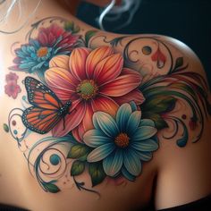 the back of a woman's shoulder with flowers and butterflies on it