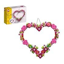 a heart shaped ornament with pink flowers on it and a box behind it