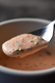 a spoon full of soup with some kind of sauce on it