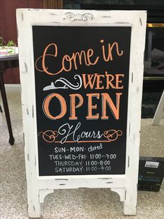 a sign that says come in we're open hours