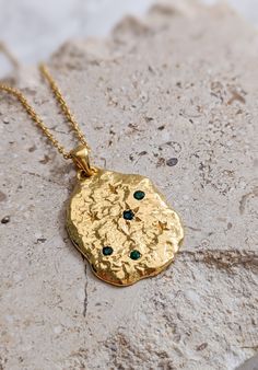 Stunning hammered gold vermeil organic disc pendant. Featuring Celestial themed engraving and set with four natural emeralds, this is a stunning piece for summer and will look gorgeous against glowing skin and floaty dresses!  This pendant is gold vermeil, which is a thick coating of gold over sterling silver. our gold vermeil is thicker than the industry standard so should have longevity with good care.  *This listing is for the pendant only and does not come with a chain* View our full collect Dainty Gold Necklace With Emerald, Dainty Gold Emerald Necklace Gift, Hammered Amulet Style Coin Necklace Gift, Hammered Amulet Coin Necklace Gift, Hammered Amulet Coin Necklace As Gift, Dainty Emerald Gold Necklace, Gold Dainty Emerald Necklace, Gold Emerald Gemstone Necklace Gift, Gift Emerald Necklace Tarnish Resistant