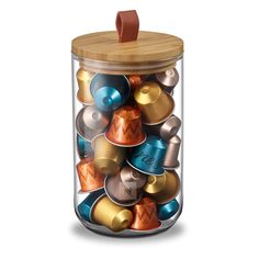 a glass jar filled with lots of different types of metal and wood objects on a white background