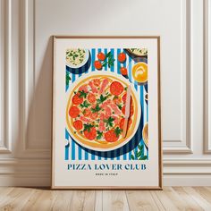 a pizza poster hanging on the wall next to a table with plates and utensils