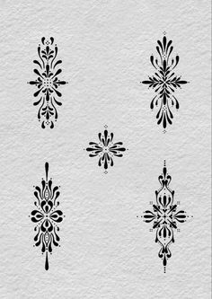 six black and white designs on paper with watermarks in the shape of snowflakes