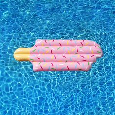 an inflatable pool float with sprinkles floating on top of it