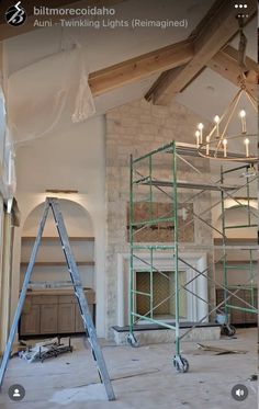 an unfinished room with scaffolding and lights on the ceiling is being worked on