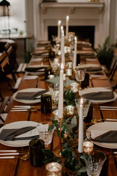 the table is set with candles and place settings