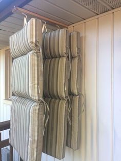 several pillows are stacked up against the wall