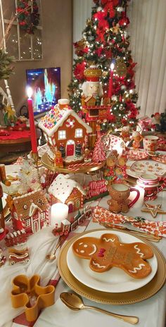 a table set for christmas with gingerbread cookies