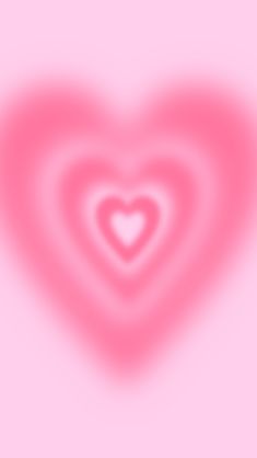 a blurry image of a heart shaped object on a pink background with white and red highlights