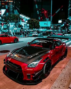 a red sports car is parked on the street