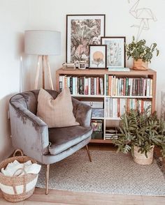 a living room filled with furniture and bookshelves next to a wall covered in pictures