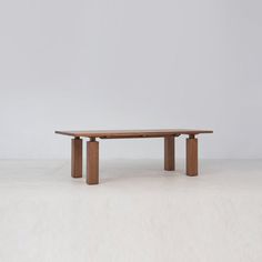 a wooden table sitting on top of a white floor