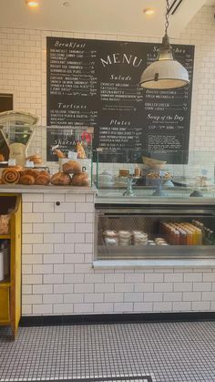 the interior of a bakery with breads and pastries