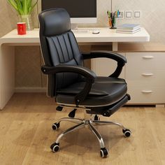 a black office chair sitting in front of a desk with a computer monitor on it