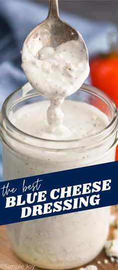 the best blue cheese dressing in a glass jar with a spoon sticking out of it