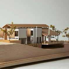 an architectural model of a house with trees in the yard