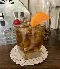 a glass filled with ice and an orange slice