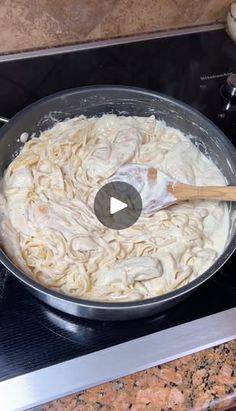 a pan filled with pasta on top of a stove