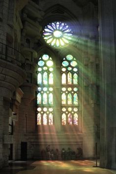 sunlight streaming through the stained glass windows in an old church