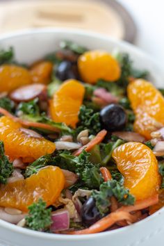 a white bowl filled with oranges, broccoli and other vegetables