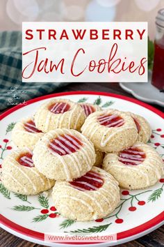 strawberry jam cookies on a plate with holly leaves