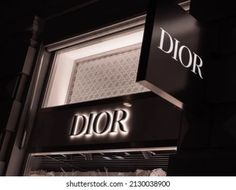 a dior store front lit up at night with the word dior on it