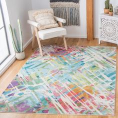 a colorful rug in the corner of a room with a chair and cacti