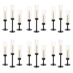 eight candles are arranged in rows on black bases