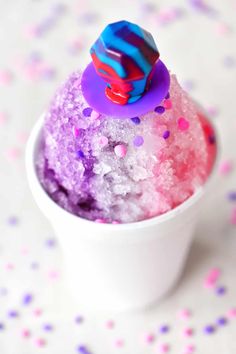 a cup filled with purple and pink sprinkles