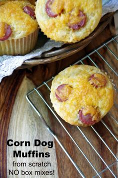 two muffins with bacon on them sitting on a cooling rack next to another muffin